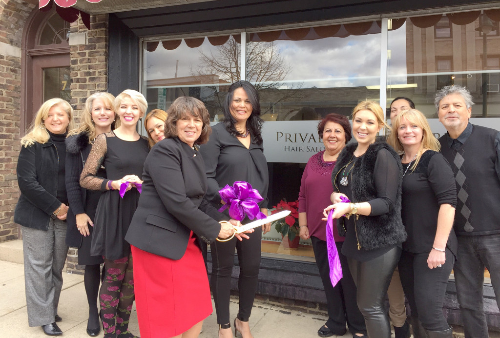(above) Privado Salon owner Miberly Cardenas, along with members of the Chamber of Commerce, Mayor Ellen Dickson, and a team of the salon’s hair stylists, celebrate at the ribbon cutting in front of Privado’s new downtown Summit location on Beechwood Road.