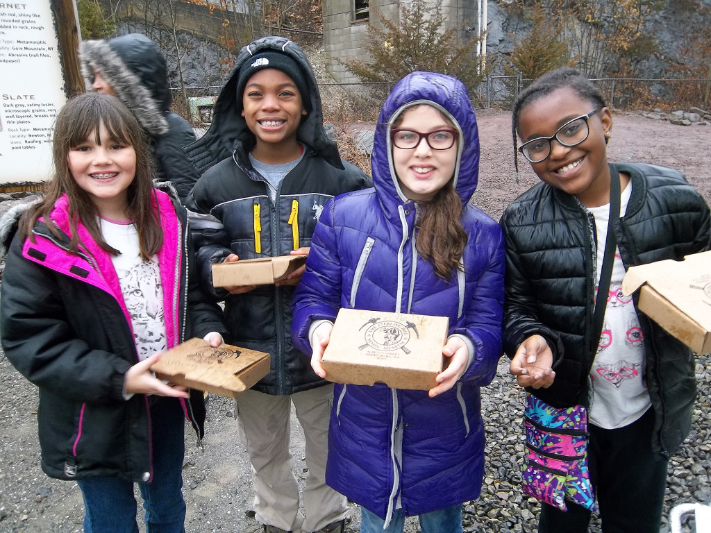 (above l-r) Students from Mrs. Prakapas's class, Amanda Puga, Rashad Jones, Giselle DoCarmo, and Jewel Hicks after collecting and identifying their souvenir rocks and minerals.