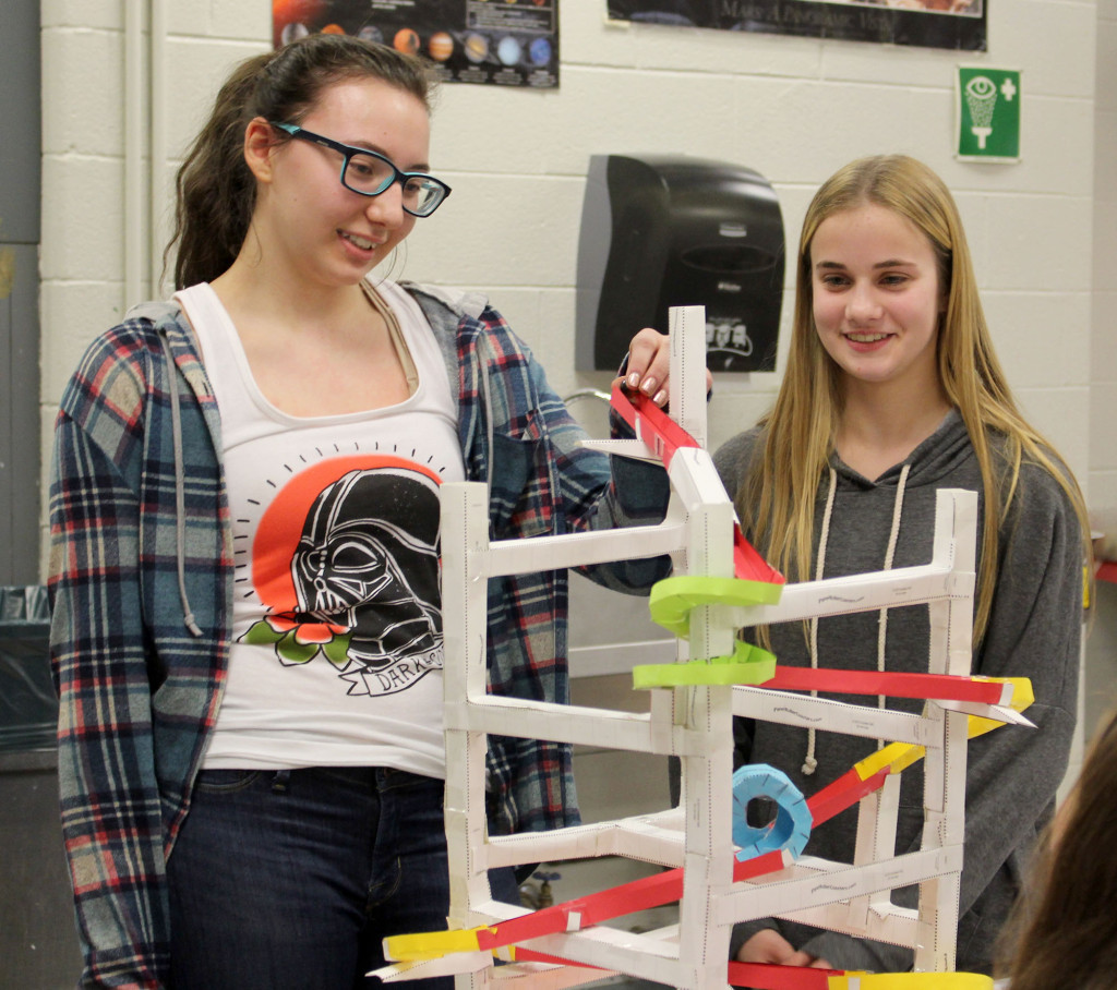 (above) Warren Middle School 7th graders Hunter Miller (L) and Kaitlyn Loia use a marble to test their paper roller coaster.