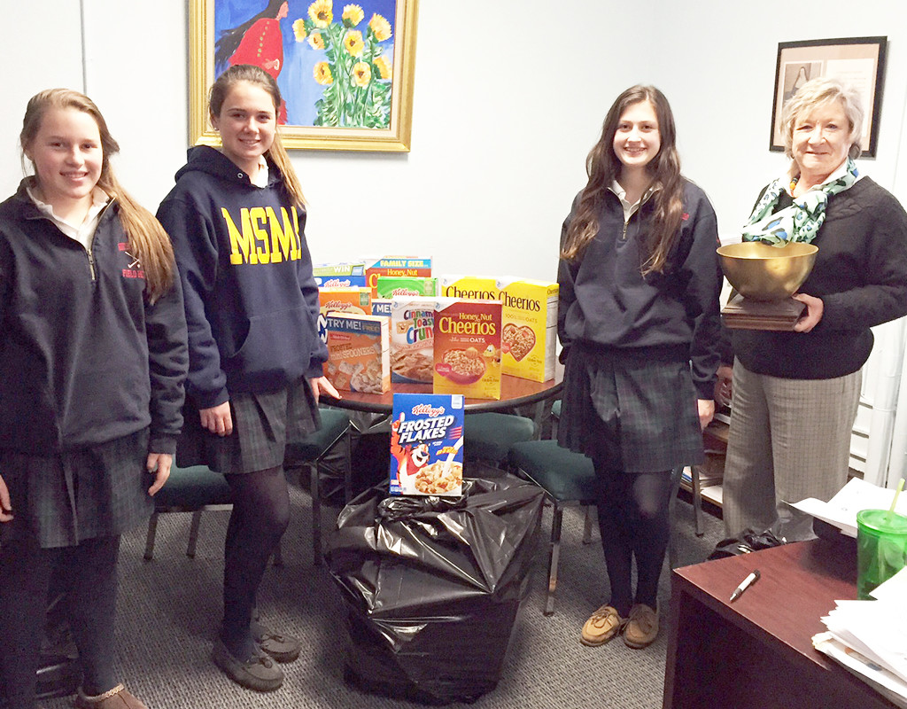 (above, l-r) Caroline Hendrix, a freshman from Westfield, Katie Butler, a sophomore from Warren, and Fiona Hadley, a freshman from Florham Park. Three members of the HOPE (Helping Other People Everywhere) club at Mount Saint Mary Academy in Watchung are pictured with some of the donated cereal boxes that will be distributed by Star Fish Food Pantry.