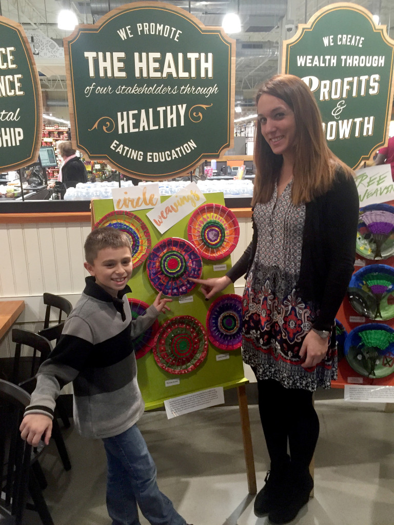 (above l-r) Second grader Jonah Bencivenga proudly points out his circle weaving with his art teacher Michelle Matesic.
