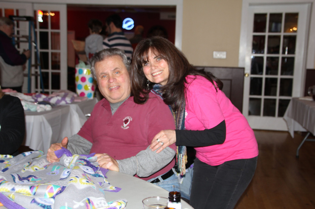 (above) Lois Pagano and Tony Plesh of Summit Elks Lodge #1246 making baby blankets for Summit Christ Child Society's Layettes Program.