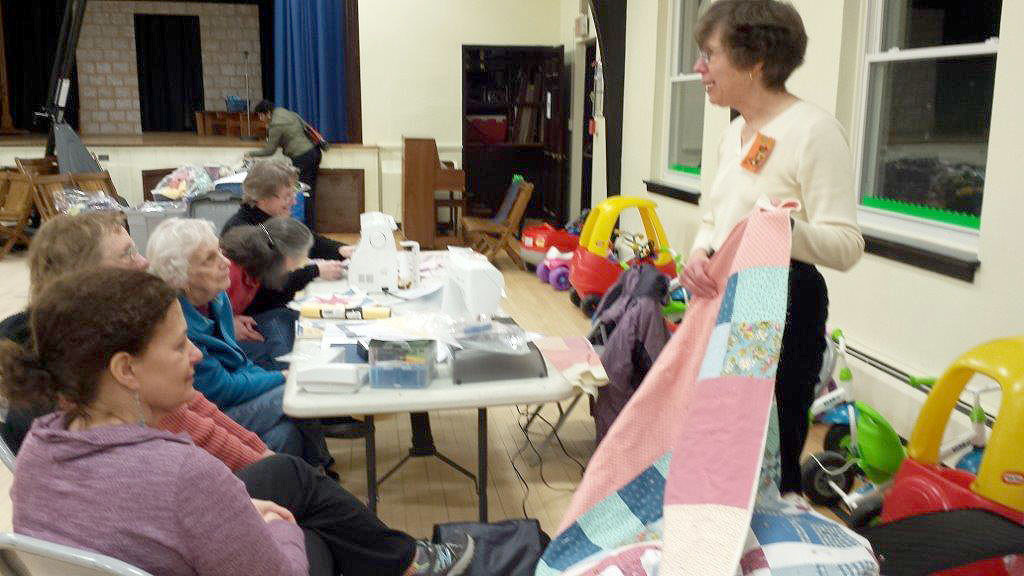 (above) Nancy Bassman, co-chair of Needle Nite shows one of the 9Patchtastic quilt patterns at the March meeting.