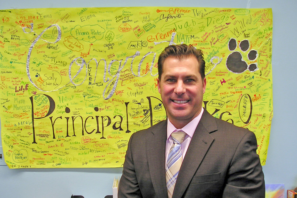 (above) The Westfield Board of Education unanimously appointed David Duelks Principal of Tamaques Elementary School, where he served as Acting Principal for 10 months. A congratulatory poster signed by Tamaques students and staff adorns his office wall.