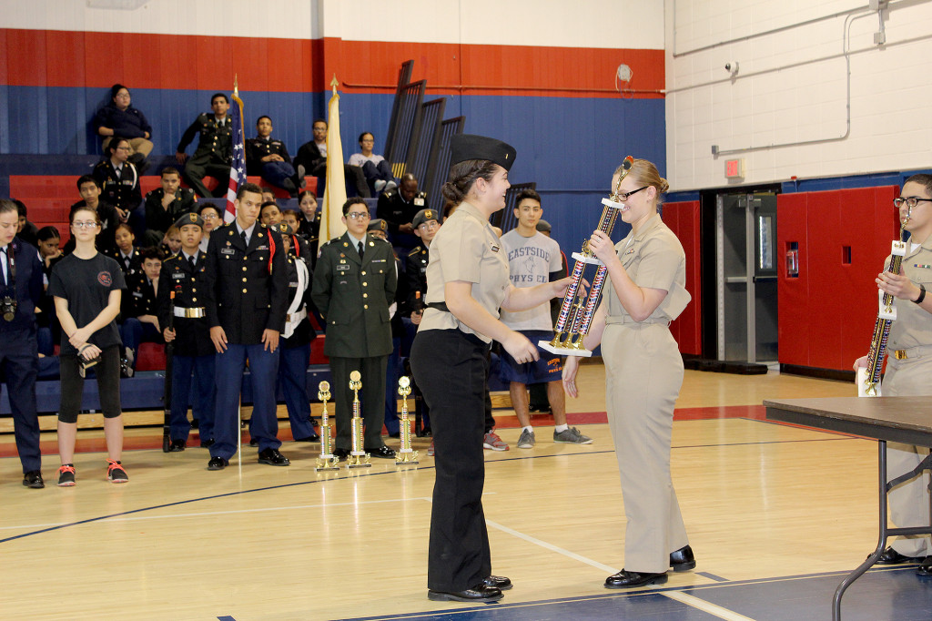 (above, l-r) Cadet Ensign Shanice Burgos Drill team commander receiving the 2nd place overall trophy.