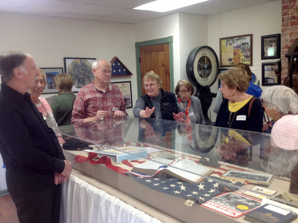 (above) Shows Diddy Addario (center), a member of the Watchung Historical Committee, explaining an exhibit to the seniors.