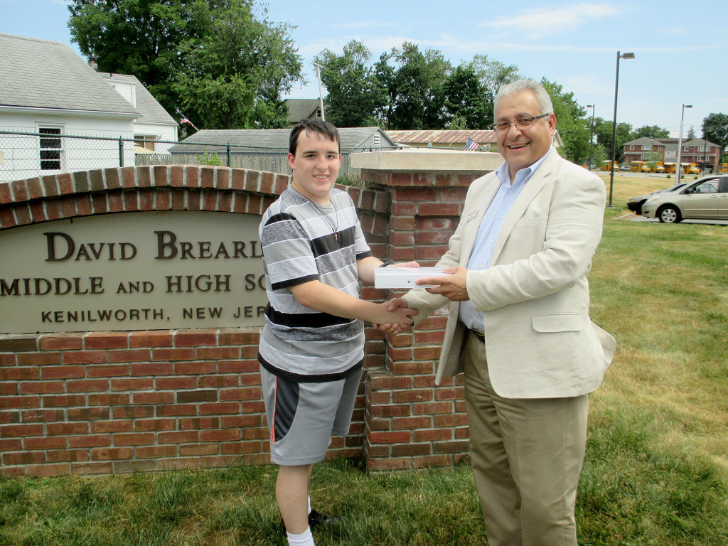 (above) Jonathan Zobek, a graduating Senior from David Brearley High School, is this year's recipient of the Kenilworth Chamber of Commerce Scholarship Award. He was presented with an Apple iPad Air Wi-Fi 64 GB on June 27th by Kamal Assad, chair of the Kenilworth Chamber of Commerce and owner of Signarama in Kenilworth, NJ.