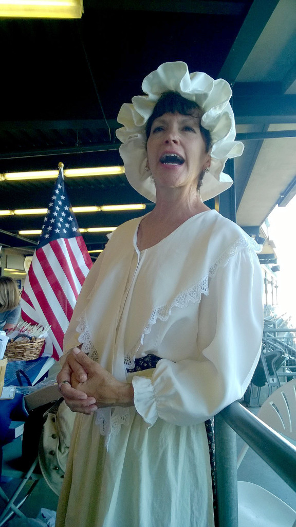 (above) Kathy Arminio, a trustee of the Union Township Historical Society, dressed in traditional colonial garb, welcomes fans at the Caldwell Parsonage table on the concourse of the TD Bank Ballpark in Bridgewater, NJ. Five other members of the Society represented Union.