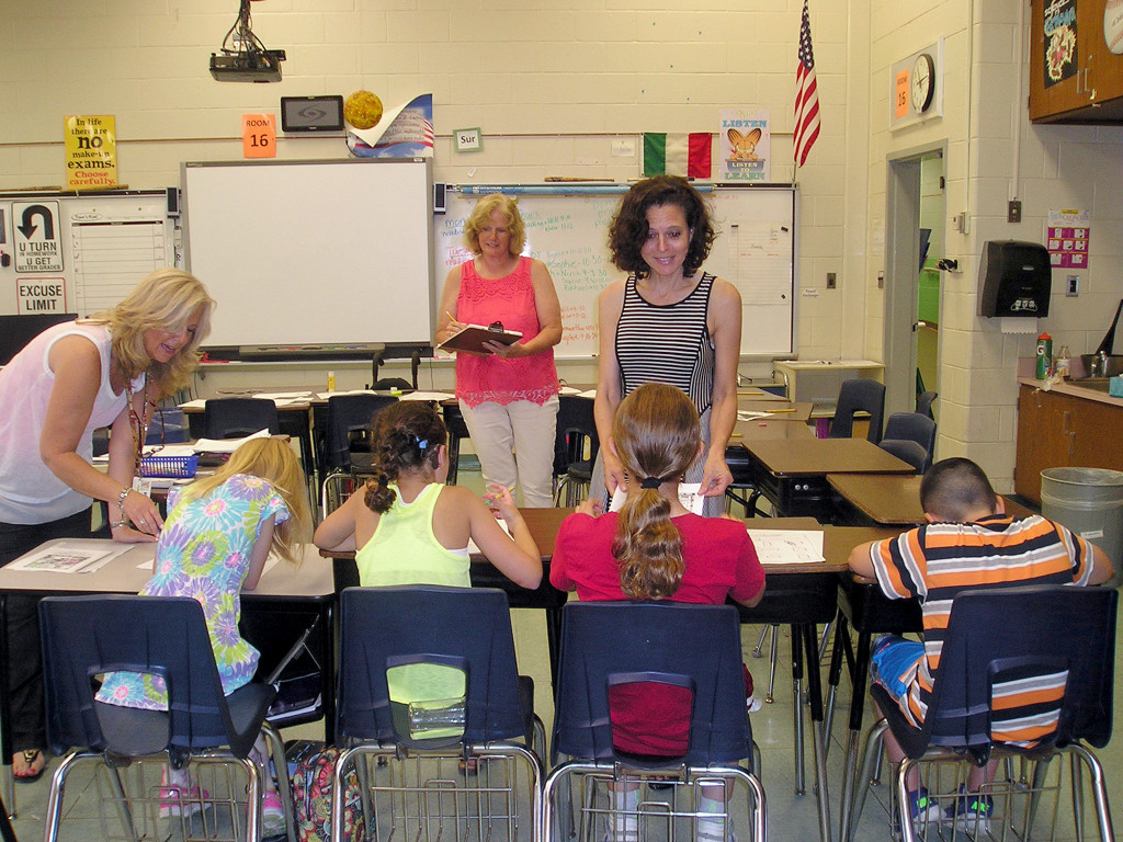 (above) Robin Gasson, teacher in the Westfield Public Schools (center front), works with elementary students in the district’s Extended School Year program to help them advance toward attaining their goals in preparation for the new school year. Paraprofessional Debbie DeNicola provides assistance, while Program Director, Joanne Ryan, records her observations.