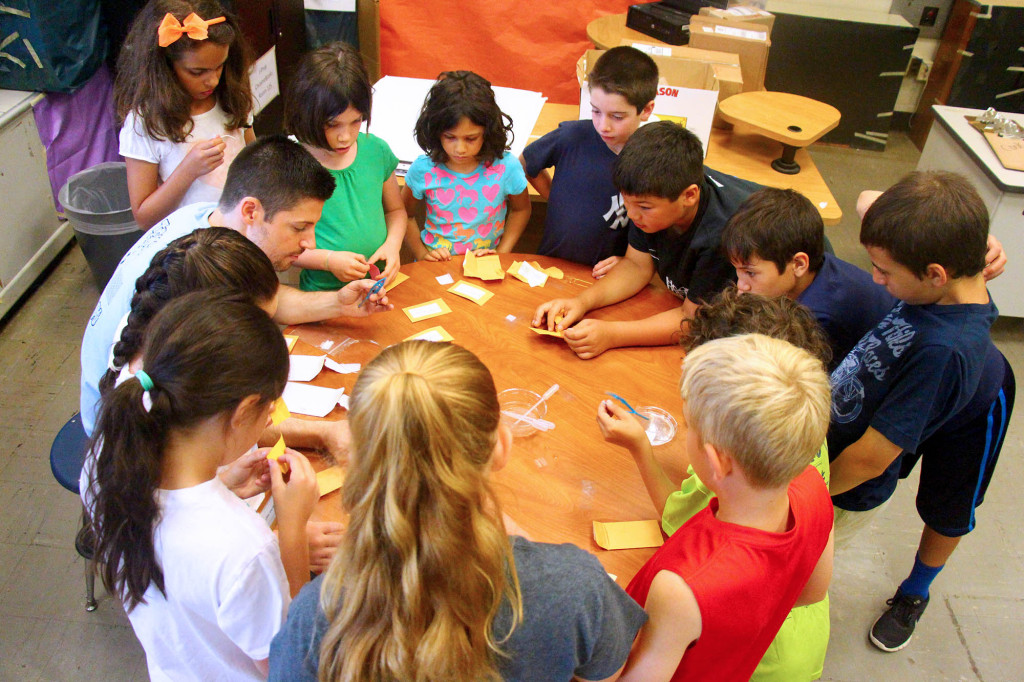 (above) At Westfield Public School District’s summer STEM camp, students learn how to prepare slides for use under microscopes during the CSI-themed Forensics Workshop. Led by Roosevelt Intermediate School Science teacher, Andrew Bausch, students at the table include Sophia Silecchia, Gabriella Zerafa, Hannah Burton, Joseph DeMattina, Cody Lam, Evan Alvarez, Aiden Alvarez, Joseph Michaeli, Lincoln Meyers, Erin Doherty, Sienna Pastore, and Quinlan Doherty. They are among the more than 340 campers entering grades 3-8 attending the popular camp, now in its fourth year.