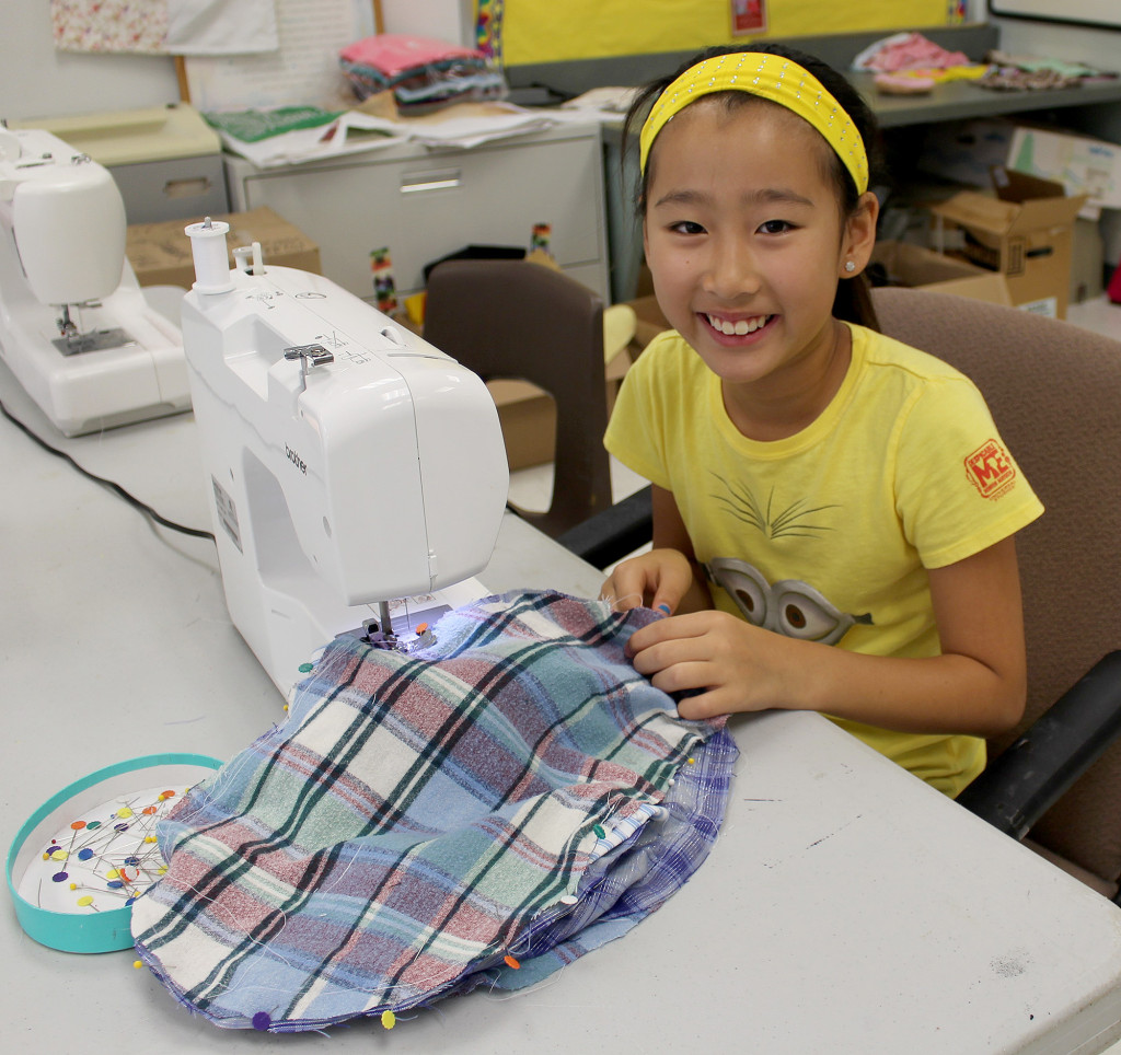 (above) Sew fun. Sixth grader Elina Xu sews a flip flop pillow in this popular Summer Fun sewing class by Susan Leonard, a second grade teacher at Woodland.