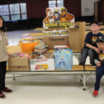 Woodland school books collected with volunteers Afseneh Thursfield and Lion scouts Brandon Bellish and Anthony Patricco 2