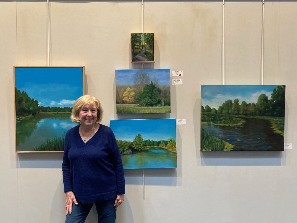 Chatham Artist Sally Abbott is shown with some of her paintings of the Great Swamp