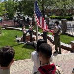 Nathaniel-Phillips-Joseph-Radics-Manal-Jha-and-Leonard-Yu-raise-flag